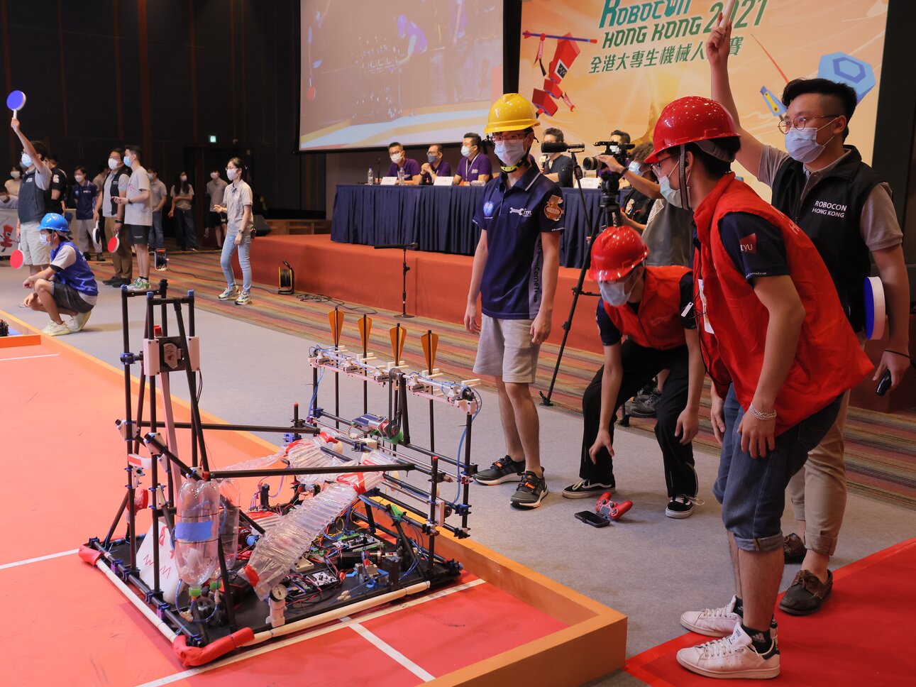 Photos 3 - 4: Each team is required to design two robots – one throwing and one defensive, to implement a series of strategic moves to shoot arrows into the pots.