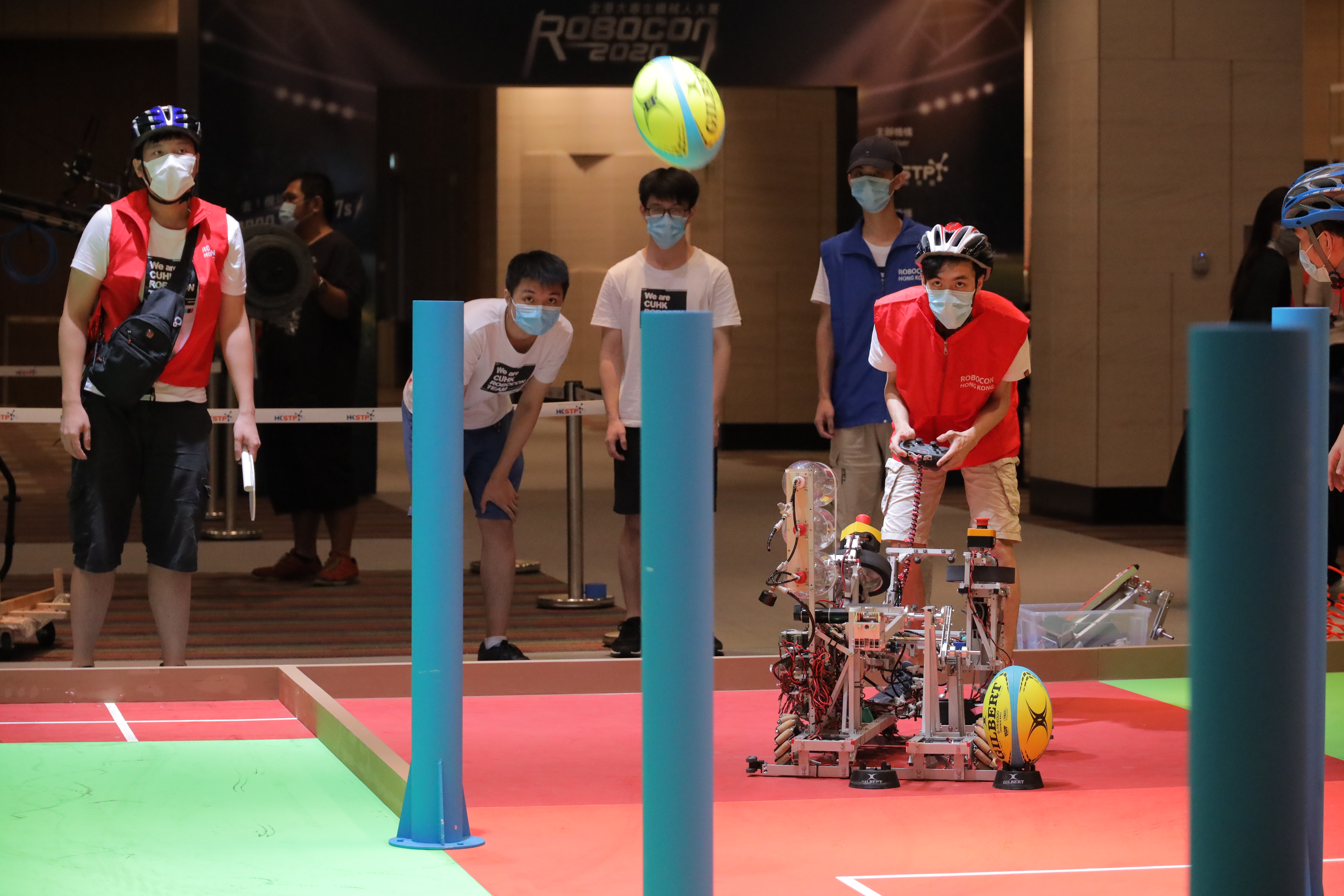 Photo 2 - 4: Robots designed by participating teams had to pass the ball, overcome obstacles and make goal kicks in the game field.