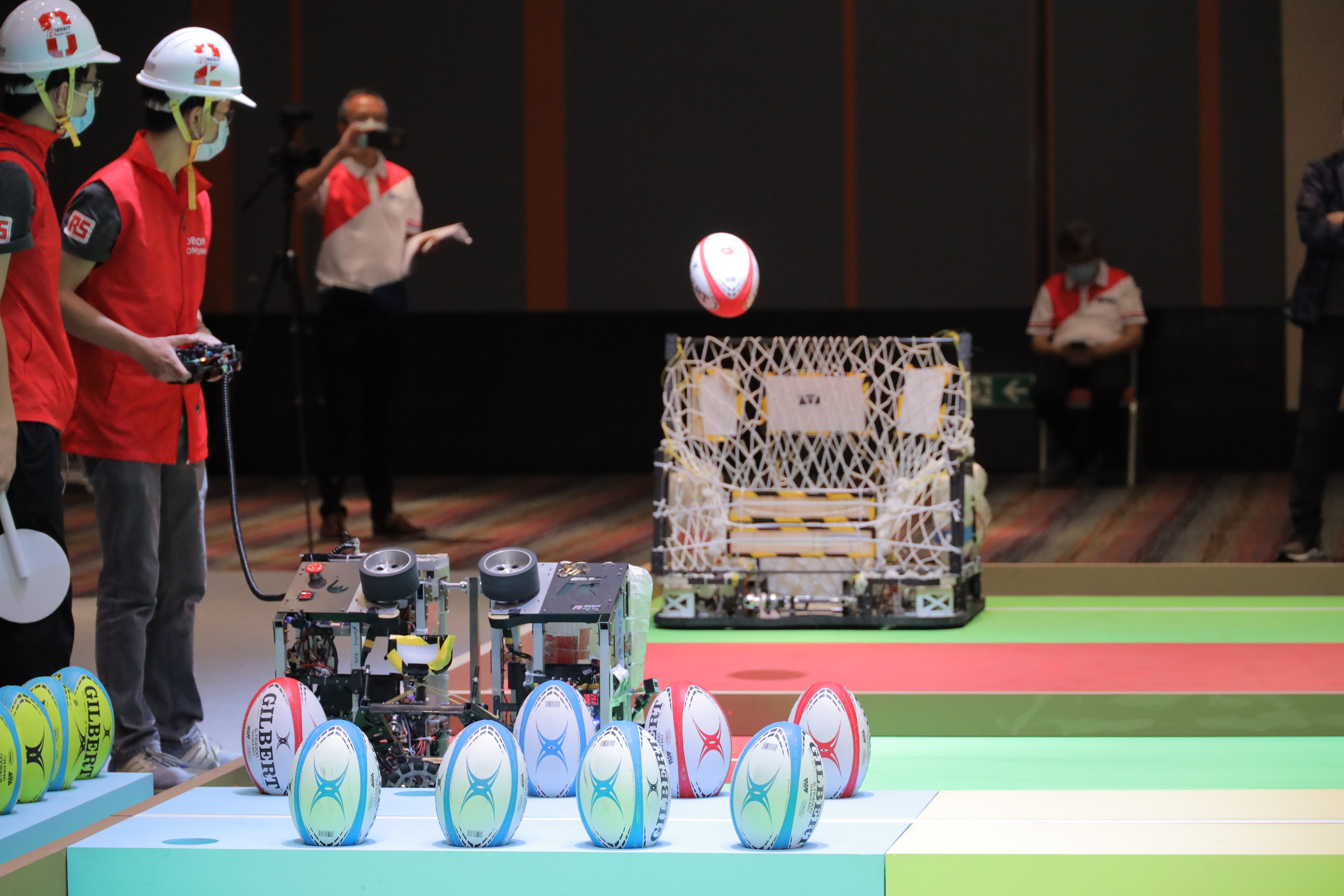 Photo 2 - 4: Robots designed by participating teams had to pass the ball, overcome obstacles and make goal kicks in the game field.