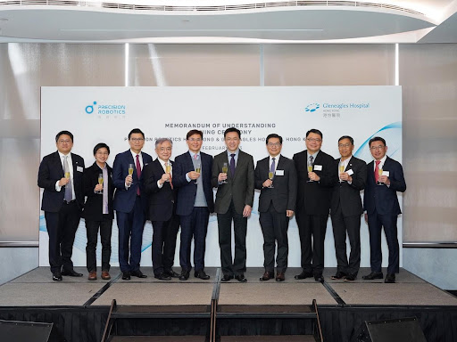 Photo 5: Group photo featuring officiating guests toasting the success of the partnership  (From the Left: Dr. Benny Lo, Dr. Lydia Leung, the Honourable Duncan Chiu, Prof. Andrew Young,  Prof. Guang-Zhong Yang, Prof. Dong Sun, JP, Dr. Kenneth Tsang, Dr. Sunny Chai (Chairman of HKSTP),  Mr. Albert Wong (CEO of HKSTP), and Dr. Tong Yow Ng)